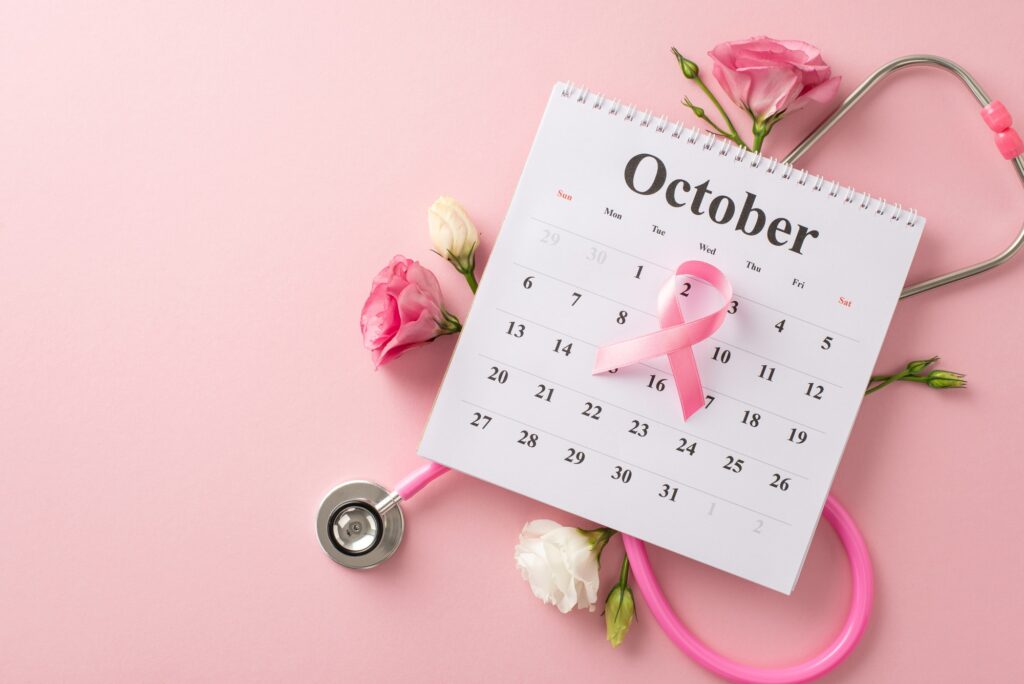 October is for raising breast cancer awareness. Top view picture featuring calendar, stethoscope
